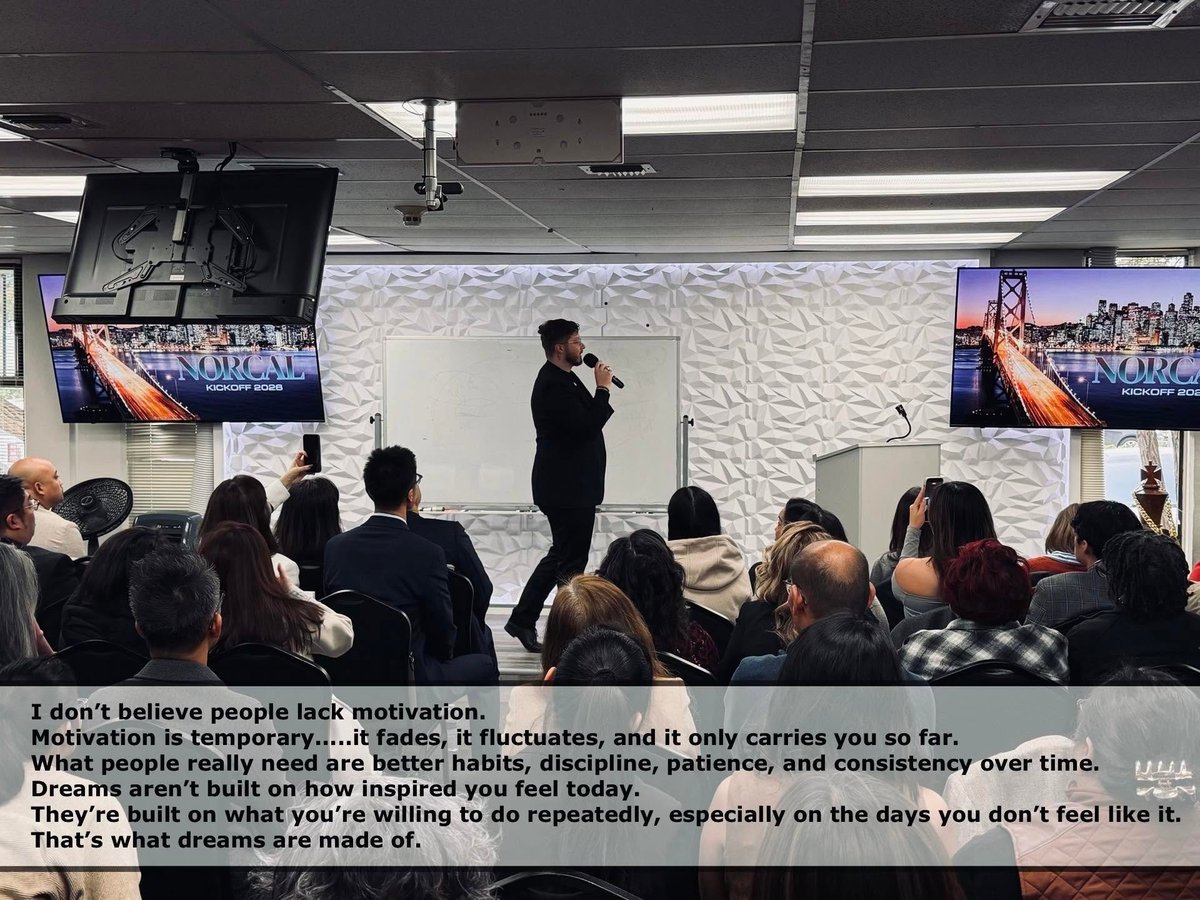 Ricky Randolph speaking on stage to a room of attendees at a Team Abnormal leadership event